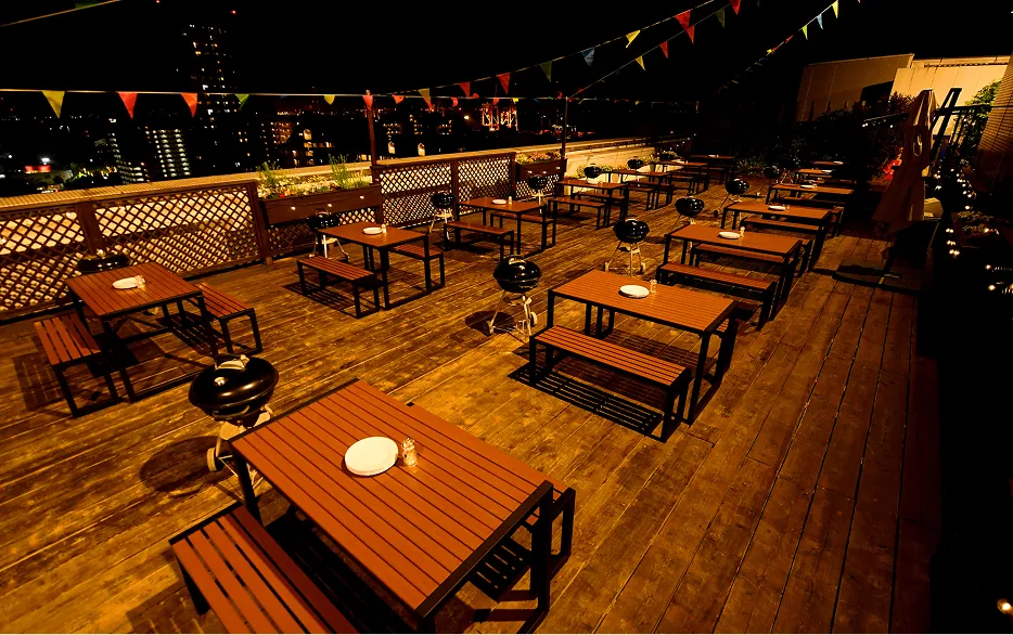 温かみのある照明でライトアップされた夜のBBQテラス